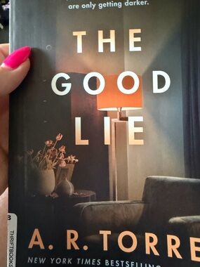 The Good Lie Hardcover Book — Black Cover with Pink Accent